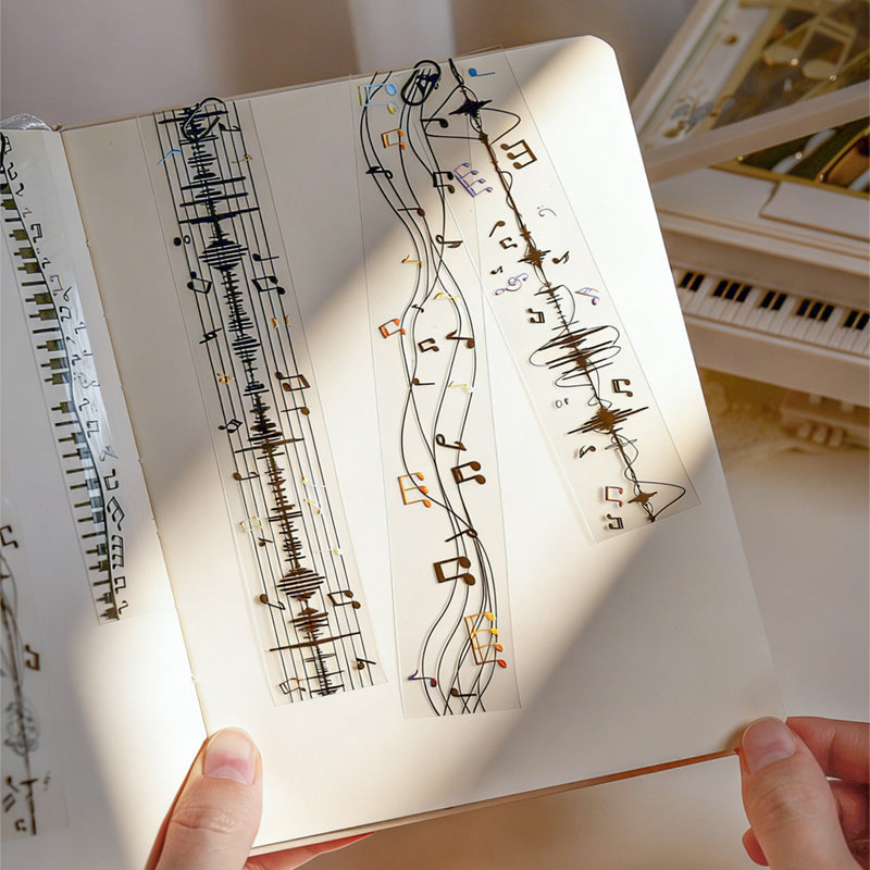 The Music Flow Series Laser Silver PET Tape featuring silver, and music designs for journaling, scrapbooking and collage