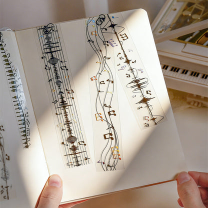 The Music Flow Series Laser Silver PET Tape featuring silver, and music designs for journaling, scrapbooking and collage
